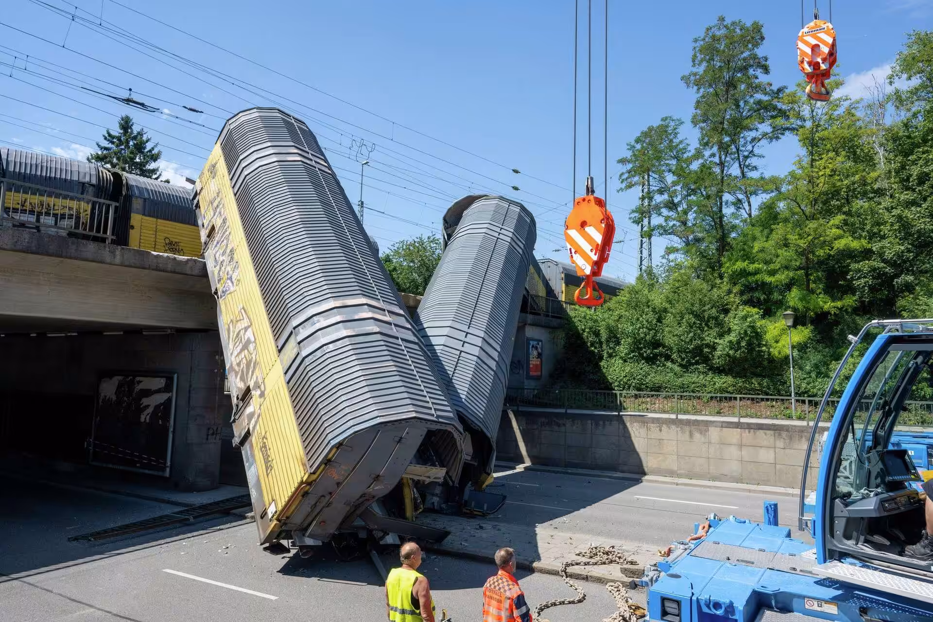 Freight train crash in Germany leaves 1 dead, two wagons dangling off bridge