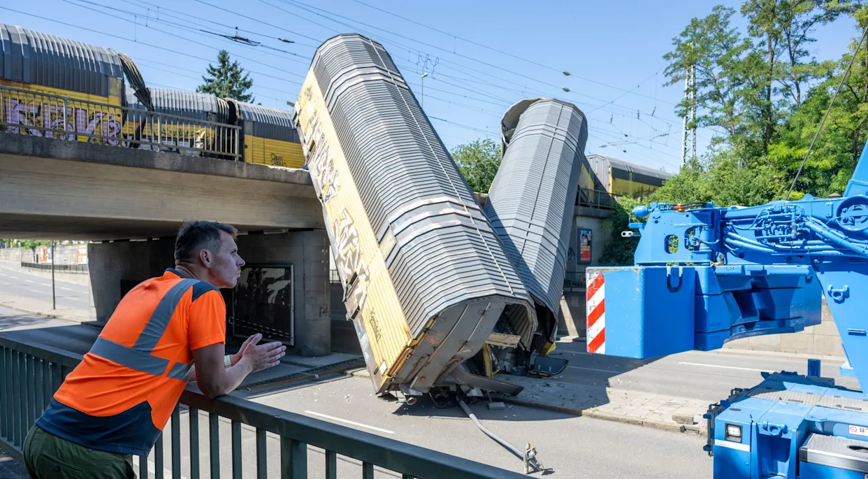 Freight trains' collision in Germany sends 2 wagons plunging off a bridge. One person was killed