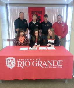 Liberty-Union High School’s Aubrey Dunfee is joined by family, coaches and administrators as she signs to continue her running career with the University of Rio Grande. Pictured are, from left to right, (seated) Liberty-Union coach Renee Mangette, Aubrey Dunfee, Rose Witham; (standing) Liberty-Union athletic director George Shire, Rio Grande director of Track & Field/Cross Country Steve Gruenberg, Rio Grande assistant coach Nick Wilson, Liberty-Union High principal Ed Miller.