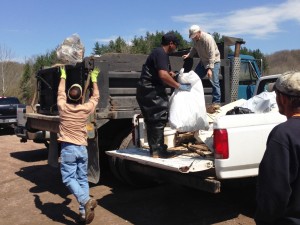 Volunteers completely filled this dump truck with litter collected from along Leading Creek and its tributary streams during the 14th annual Leading Creek Stream Sweep, which was held Saturday morning at the Meigs SWCD Conservation Area near Rutland. Here Bill Foley of Harrisonville, Ray Johnson of Middleport and Jim Freeman, Racine, transfer trash from a pickup truck into the dump truck.