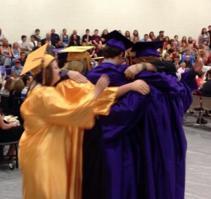 Members of the 2014 class sharing a hug before walking out the high school doors for the last time. 