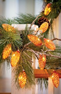  Greenery combined with decorative LED lights can brighten up holiday centerpieces and mantle displays.