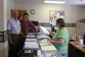 Cody and Greg giving 44 petitions, totaling 885 signatures, to Becky at BOE.